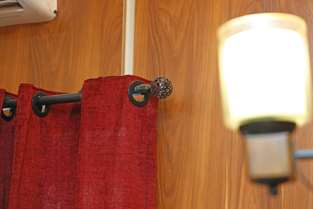Dark metal curtain rod with decorative finial