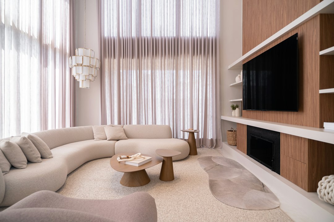 Floor-to-ceiling curtains in a modern neutral living space