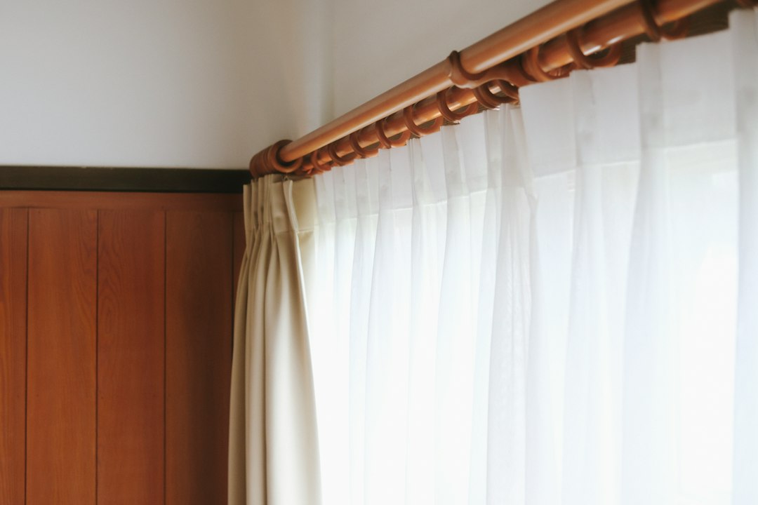 Minimal curtain track and white window treatment